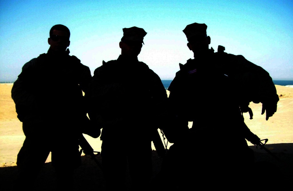 Silhouettes of three soldiers.