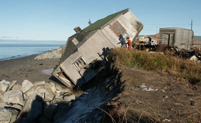 Climate change is blamed for many adverse effects, including coastal erosion, as shown here in Shishmaref, Alaska. Photo courtesy of Alaska Village Electric Cooperative. 