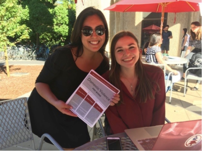 Raquel Dominguez (left) and Emma Eastwood-Paticchio share information about pro bono opportunities to assist victims of domestic violence