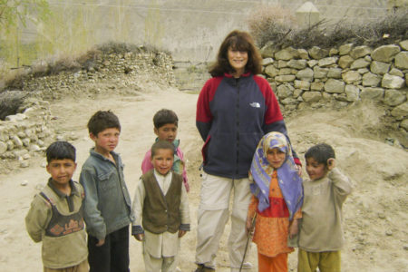 Aisha Khan is greeted by children in Testay village in the upper Braldu Valley, Gilgit Baltistan, Pakistan, during a 2011 needs assessment visit. (Image credit: Mohammad Hussain)