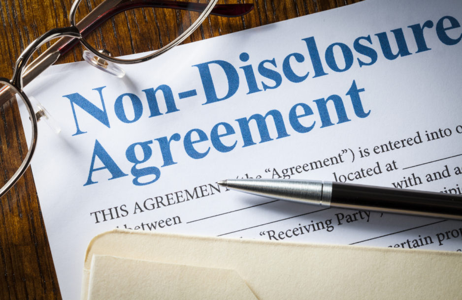 Non Disclosure Agreement with pen and glasses