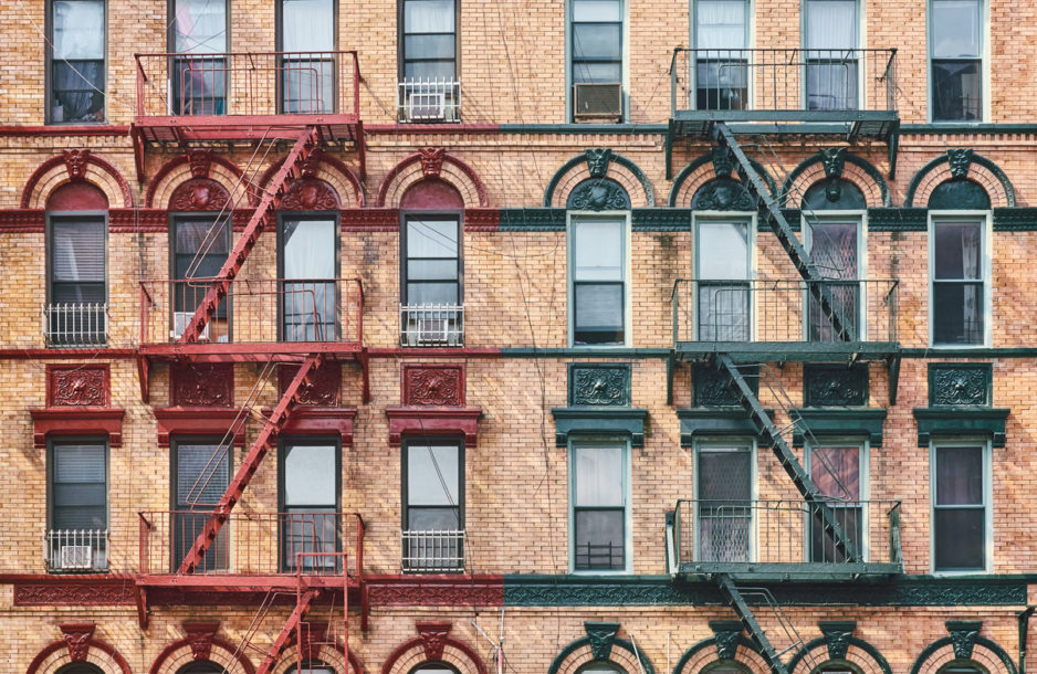 Manhattan old residential building with fire escapes, New York City, USA.
