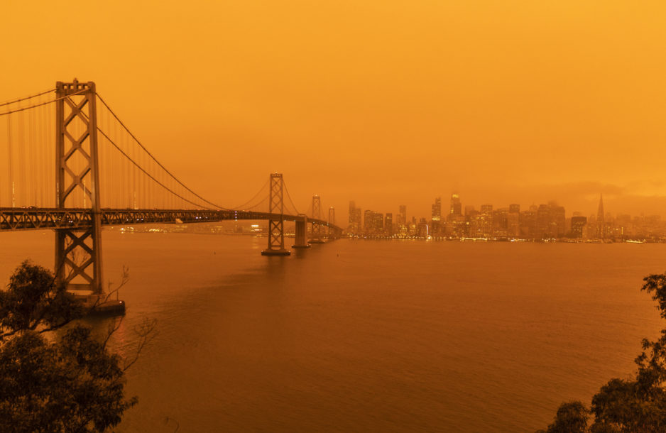 San Francisco California, USA - September 9, 2020: The sky across California darkened and stayed orange during day as smoke from many wildfires across the state created a massive smoke cloud changing the sunlight to a perpetual orange glow.
