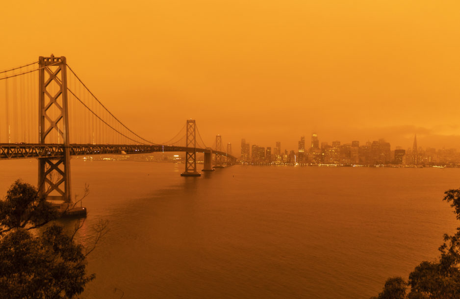 San Francisco, California, USA - September 9, 2020: The sky across California darkened and stayed orange during day as smoke from many wildfires across the state created a massive smoke cloud changing the sunlight to a perpetual orange glow.