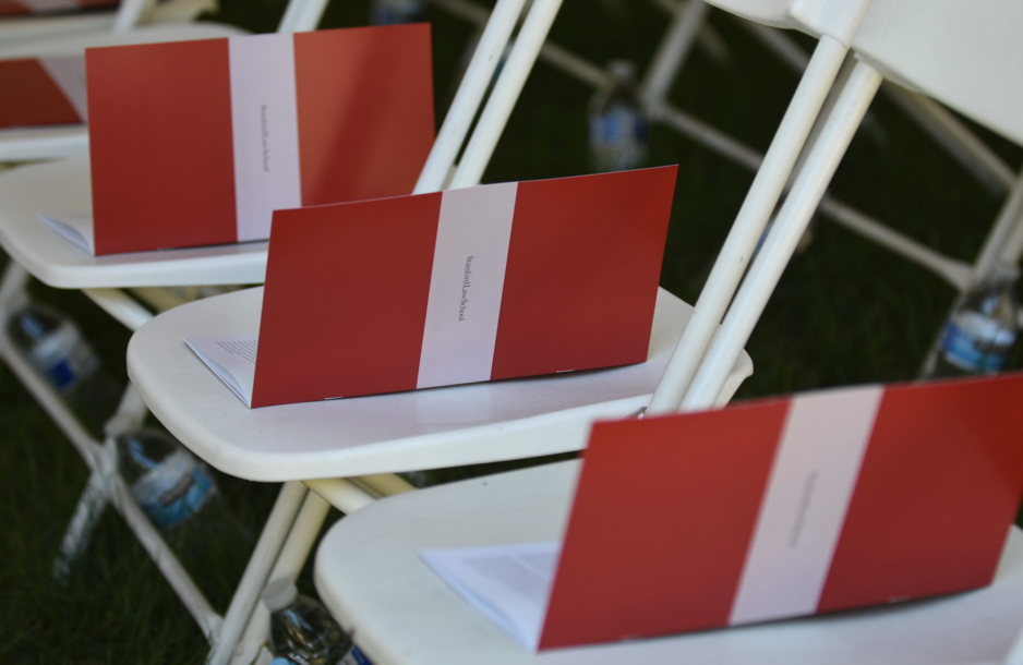 Graduation programs placed on chairs.