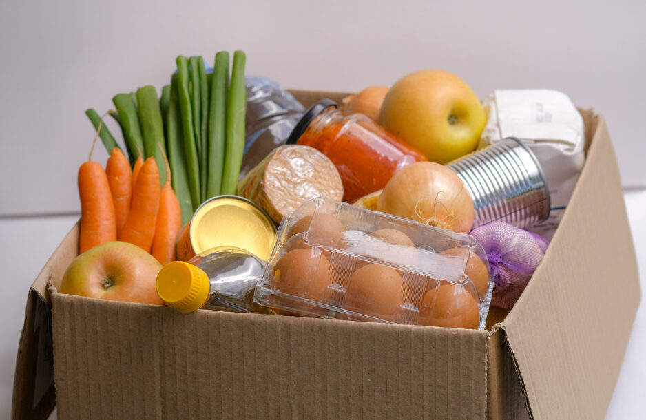 View on cardboard box with food supplies.