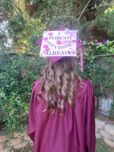 Girl in graduation gown and cap, shown from the back