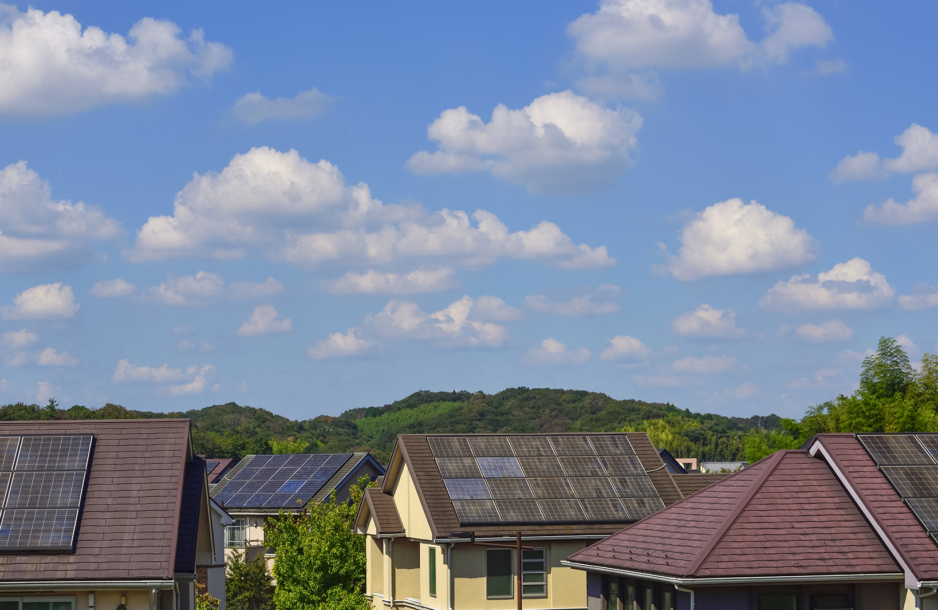 Blue sky and solar panels on houses.