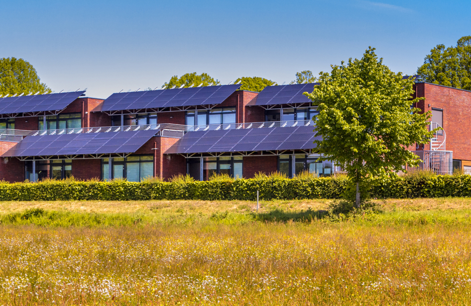 Public school building with solar panels utilized as sunlight protection.