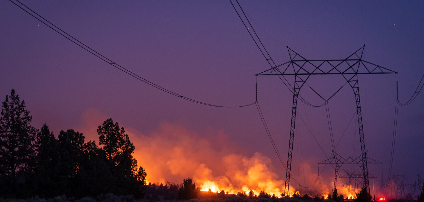 wildfire burns near transmission line