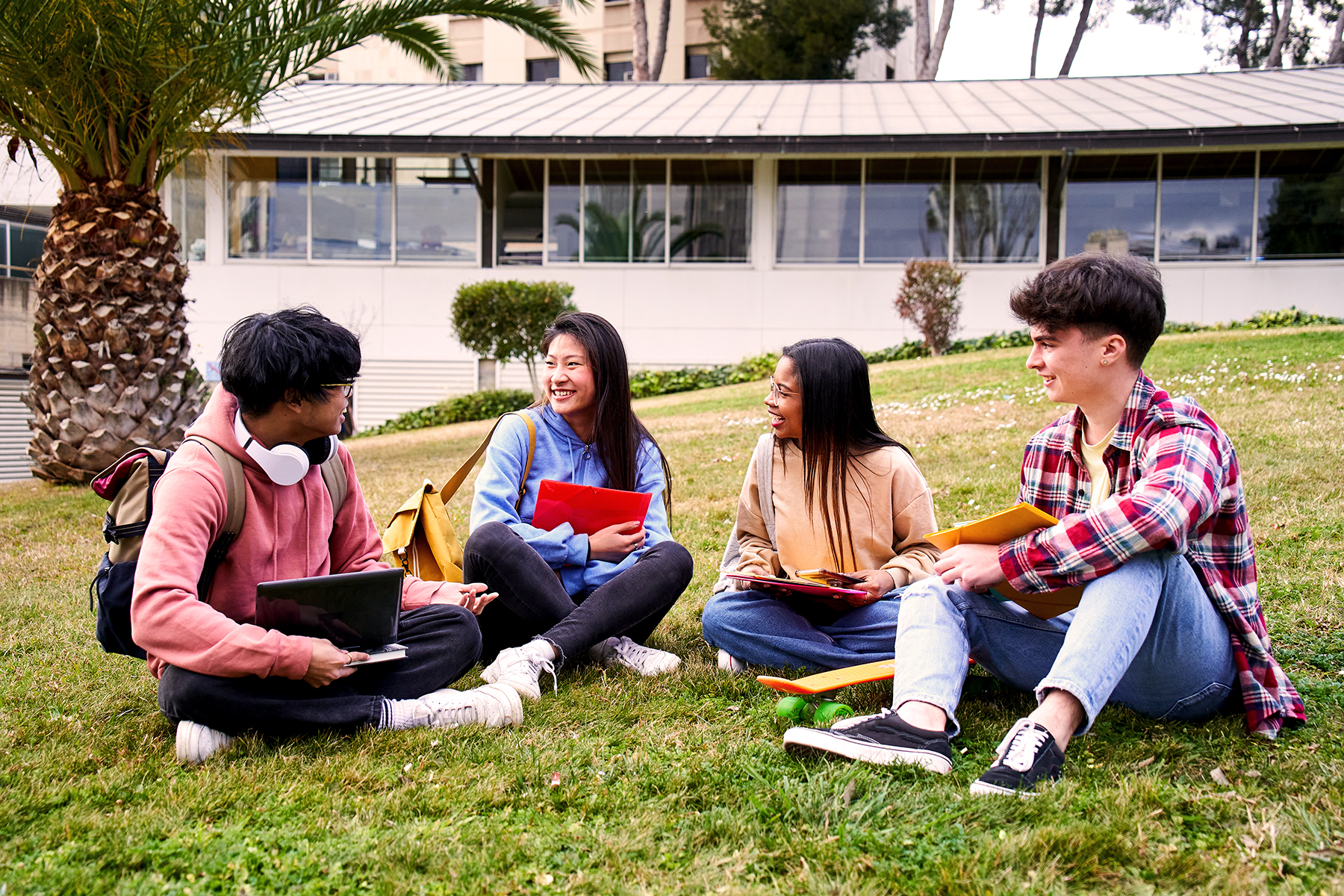 Group of high school students sitting in the grass.