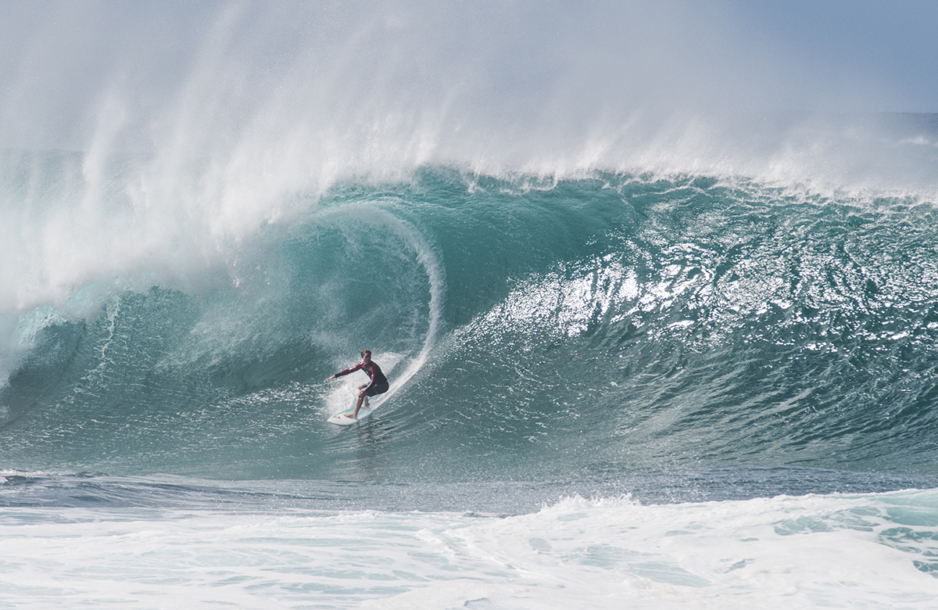 A surfer lines up a very large wave at the infamous Banzai Pipeline on the North Shore of Oahu.