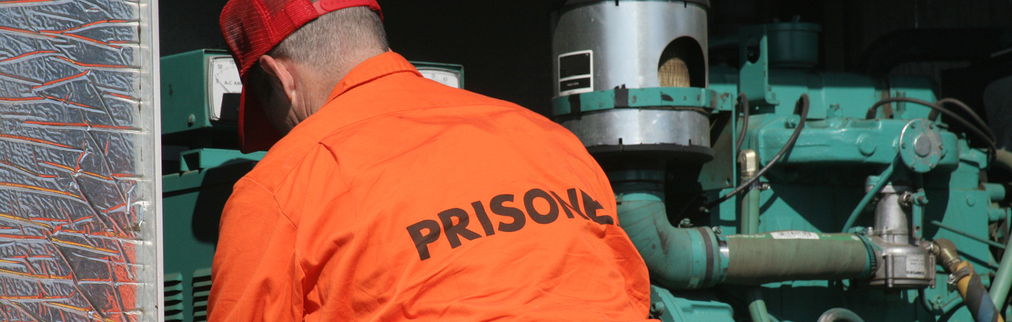 Image of a prisoner working on machinery.